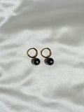 Tahitian Pearl Huggies on a white background 