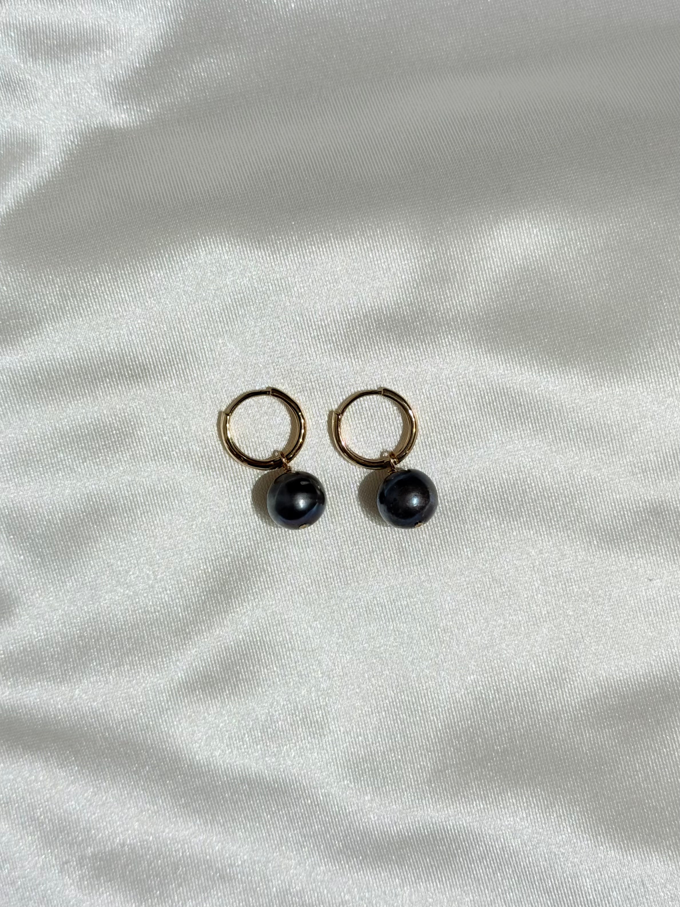 Tahitian Pearl Huggies on a white background 