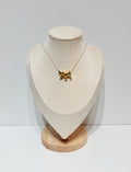 Triple gold puakenikeni flower necklace with three charms on delicate gold chain