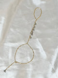 Keshi pearl hand chain bracelet with seven gray pearls along delicate gold paperclip chain draping