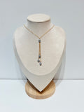 Mahina Y-drop necklace with one gray keshi pearl at center and three pearls cascading below on delicate gold chain tassels