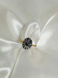 opihi awa shell ring with natural black and white line pattern on a gold band 