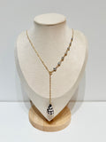 Necklace with 7 Keshi pearls tied into the chain with a Hebrew shell on a mannequin bust against a white backgrounded 